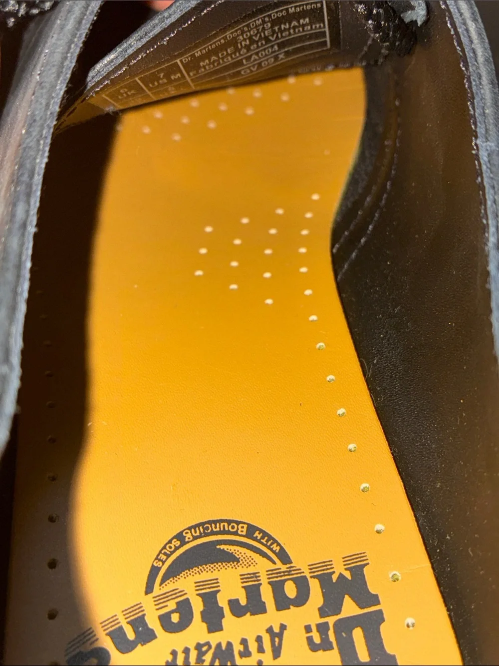 Dr. Martens 1461 leather oxfords feature the brand's signature yellow size 8